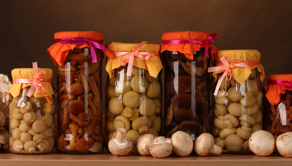 delicious marinated mushrooms in the glass jars and raw