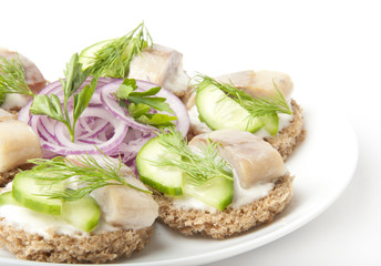 Portion of a herring with an onions and fennel