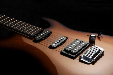 Fototapeta na wymiar close up of a elelctric guitar on dark background