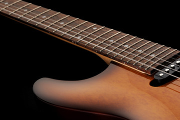 close up of a elelctric guitar on dark background