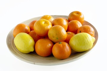 citrus fruits on wooden plate