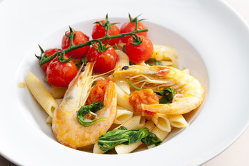 pasta penne with prawns, spinach and grilled cherry tomatoes