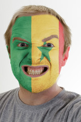 Face of crazy angry man painted in colors of senegal flag