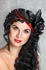 Brunette girl with long hair and red beads