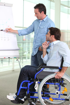 An employee pointing at a board and explaining