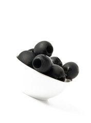 Black olives in a bowl isolated on white
