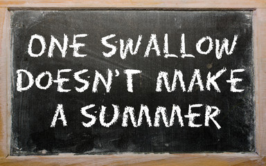 Proverb "One swallow doesn't make a summer" written on a blackbo