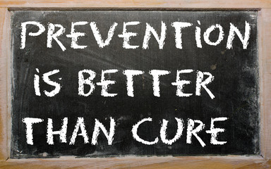 Proverb "Prevention is better than cure" written on a blackboard