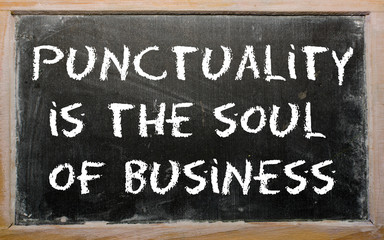 Proverb "Punctuality is the soul of business" written on a black