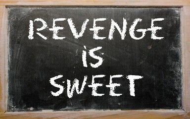 Proverb "Revenge is sweet" written on a blackboard