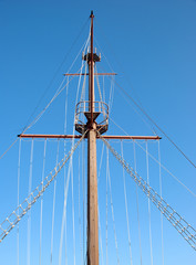 A Ships Mast and Rigging against a blue sky