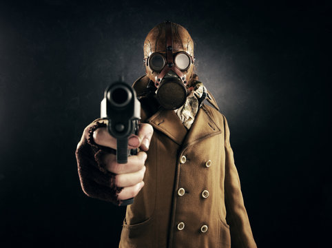 Grunge Portrait Man In Gas Mask Pointing A Gun