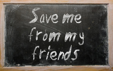 Proverb "Save me from my friends" written on a blackboard