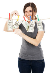 Young beautiful woman taking a dollar bill from the rope