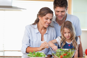 Family preparing a salad