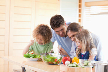 Family preparing a salad together