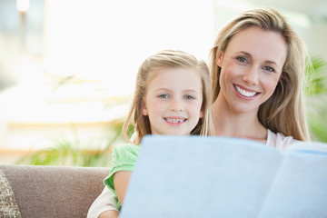 Mother and daughter reading on the sofa