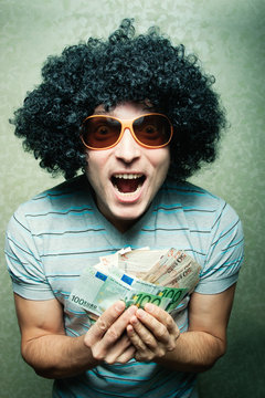 Guy In Afro Curly Wig With Eyeglasses With Lots Of Money