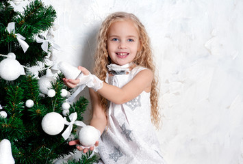 Cute blonde girl with Christmas tree