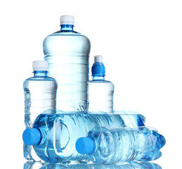 Group plastic bottles of water isolated on white