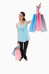 Portrait of a happy woman showing shopping bags