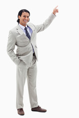 Portrait of a smiling businessman pointing at a copy space
