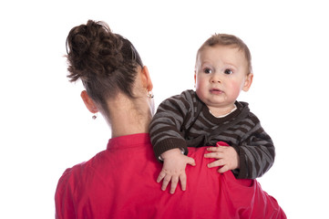 Fototapeta na wymiar Baby looking over his mother's shoulder