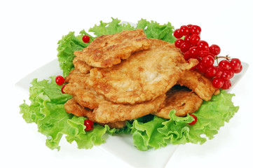 chops grilled meat with a green salad and cranberries