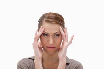 Sick woman rubbing her temples