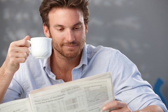 Handsome guy with newspaper
