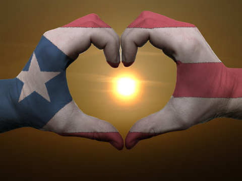 Heart and love gesture by hands colored in puertorico flag durin