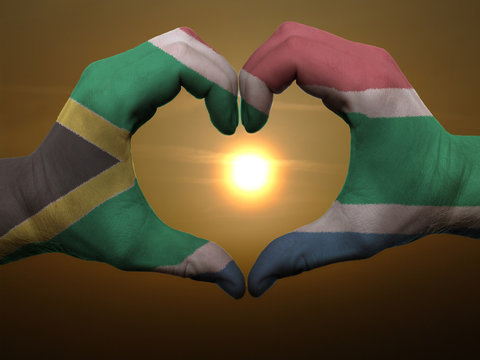 Heart and love gesture by hands colored in south africa flag dur