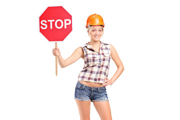 A construction worker holding a traffic sign stop