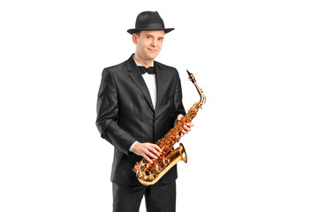A man in a suit holding a saxophone