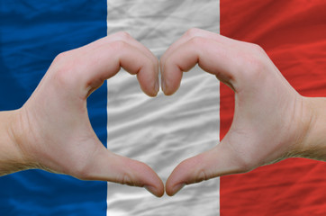 Heart and love gesture showed by hands over flag of france backg