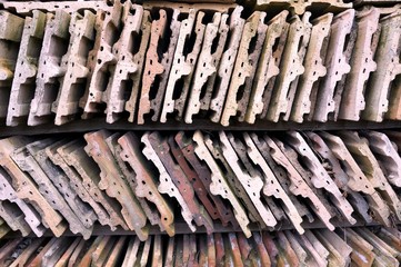 Used roof tiles stored on wooden shelves