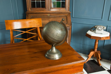 Vintage working space with desk globe