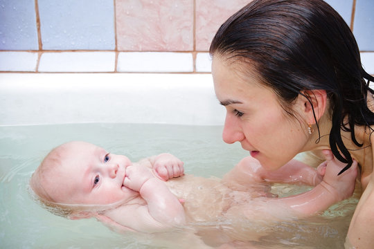 Mother With Baby In A Bathroom