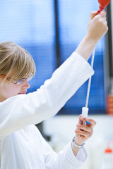 Closeup of a female researcher carrying out experiments in a lab