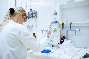 Closeup of a female researcher carrying out experiments in a lab