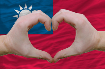 Heart and love gesture showed by hands over flag of taiwan backg