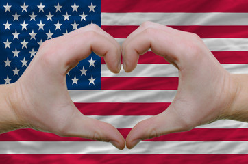 Heart and love gesture showed by hands over flag of usa backgrou