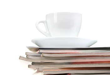stack of magazines and cup isolated on white