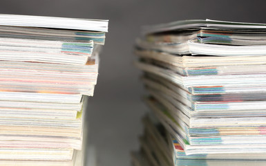 stacks of magazines on gray background