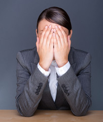 Portrait of tired business woman with face palm