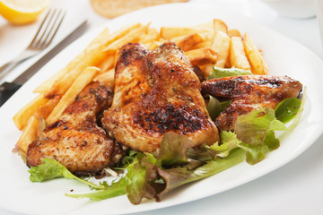 Grilled chicken wings with french fries