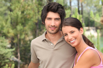 Fototapeta premium couple in pine forest near a lake