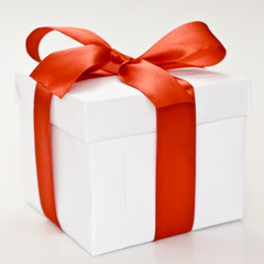 white gift box with red ribbon