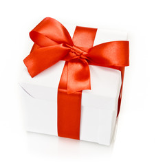 white gift box with red ribbon