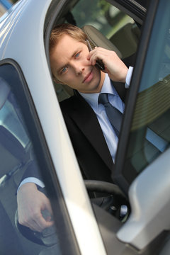 Man using mobile telephone in car